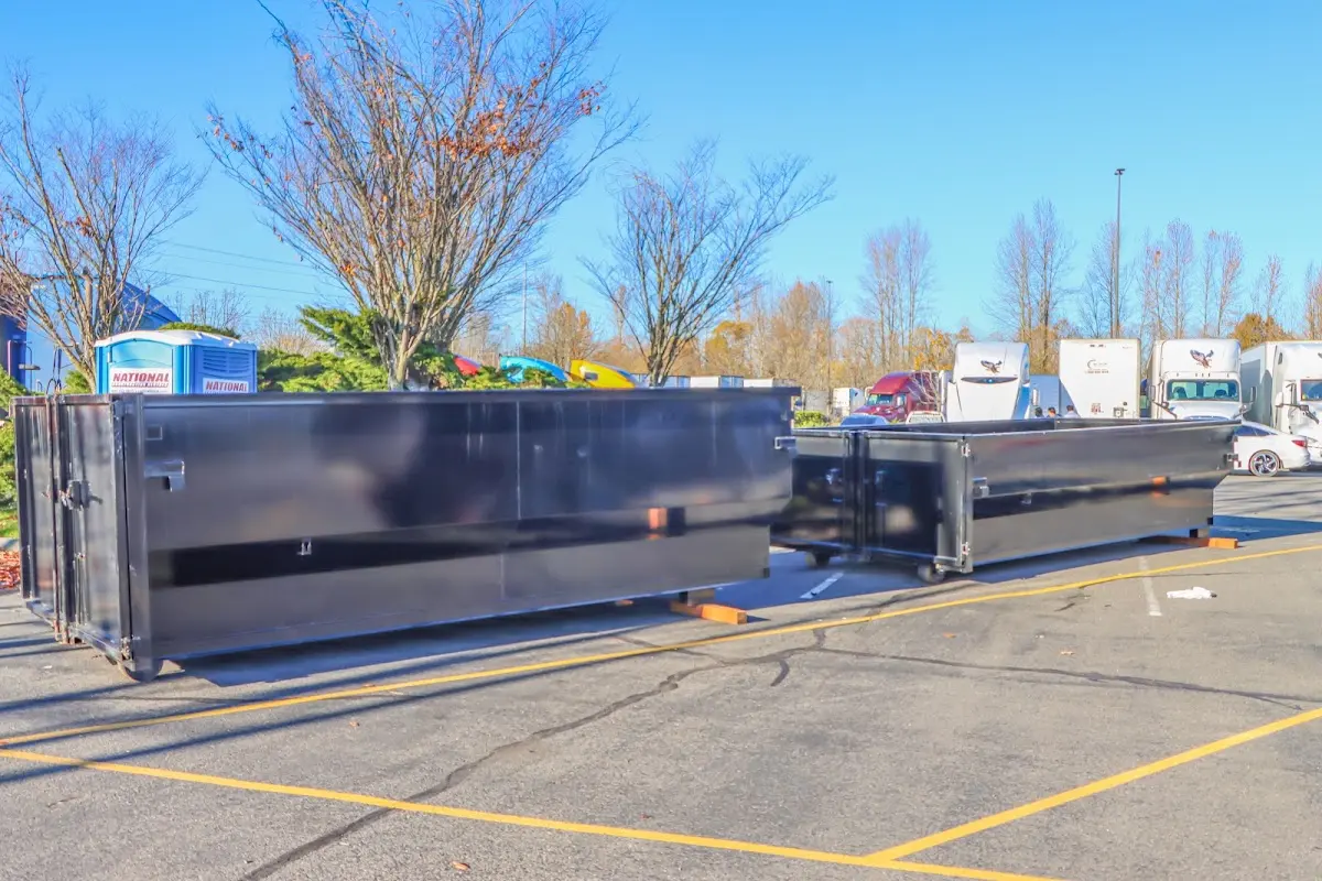 Professional dumpster rental service with roll-off container on residential driveway in Crockett